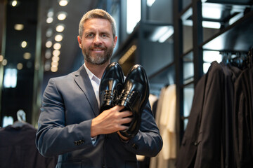 Customer in a trendy store evaluates different shoe styles. Business man confidently chooses...