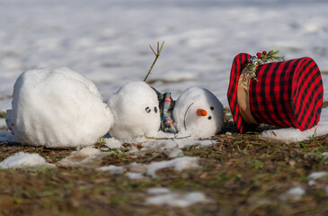 End of winter, hello spring. Melting snowman. Warming season effects. Winter and spring seasons...