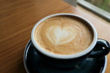 Side view of hot latte coffee with latte art
