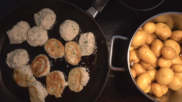 Hirtshals Denmark Fish frikadeller or fish balls, a Danish food speciality, frying in a pan.