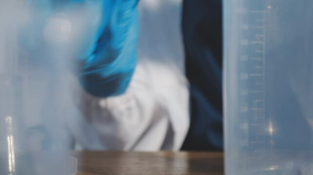 Scientist pipetting medical samples into microplate in laboratory