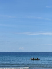 Naklejka premium Calm blue sea with boat passing by and sky with clouds. Copy space 