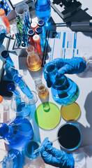 Scientist pipetting medical samples into microplate in laboratory