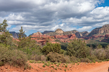 A collection of images showcasing the striking red rock landscapes and rugged desert trails of Sedona, Arizona. These photos capture the breathtaking natural beauty, rocky paths, and iconic formations
