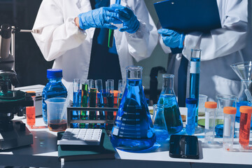 Scientist pipetting medical samples into microplate in laboratory