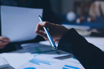 Group of business women working on a financial data expenses document.