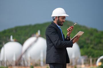 Environmental engineer manager examining waste water along large industrial construction waste...