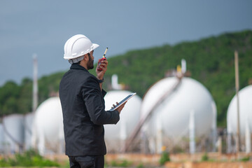 Environmental engineer manager examining waste water along large industrial construction waste...