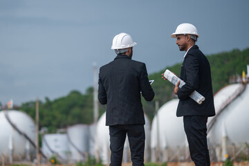 Environmental engineer manager examining waste water along large industrial construction waste...