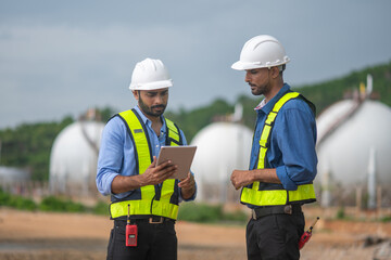 Environmental engineer or workers examining waste water along a large industrial waste water or...