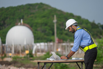 Environmental engineer or workers examining waste water along a large industrial waste water or...