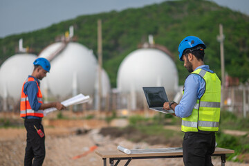 Environmental engineer or workers examining waste water along a large industrial waste water or...
