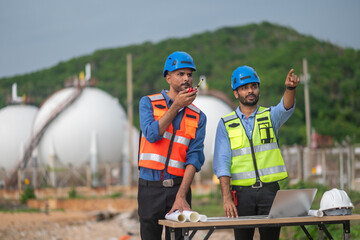Environmental engineer or workers examining waste water along a large industrial waste water or...