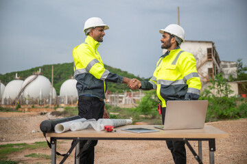 Environmental engineer or workers examining waste water along a large industrial waste water or...