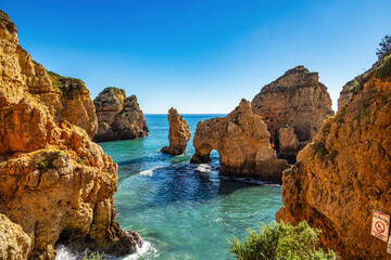 Naklejka na ściany i meble Ponta da Piedade is a unique rock formation with famous grottos in the ocean at Lagos, Algrave, Portugal