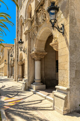 Arches and ornate details of a historic stone building in Ciutadella, Menorca, Spain.