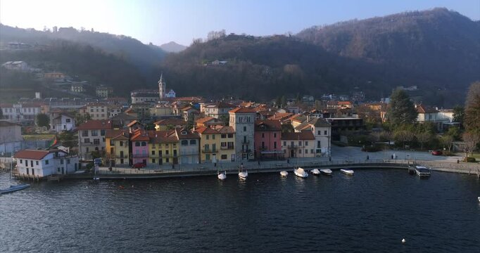 Lakeside village of Pella on Lake Orta, Italy. Aerial drone backward ascending, copy space