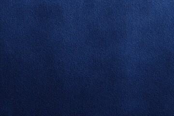 Fototapeta premium Close-up texture of dark blue denim fabric, showing detailed woven fibers and a slightly rough surface.