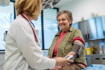 Senior woman having blood pressure checked, preventive care.