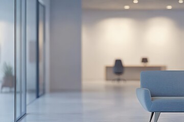 Defocused modern office room. White office with a desk and chair. The desk has a computer and a potted plant.