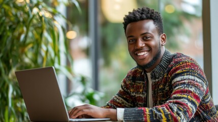 happy man working on laptop in coffee shop