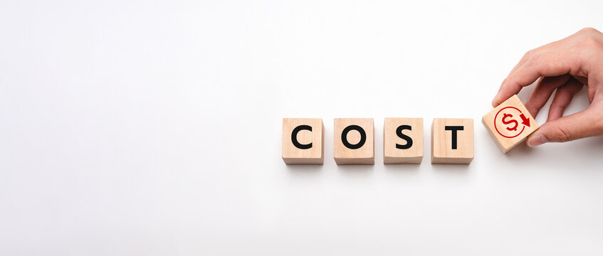 Business Concept of Cost Reduction Strategy with Wooden Blocks Spelling COST and Hand Placing Red Dollar Icon Showing Downward Arrow on White Background, Finance, Budget and Expense Optimization