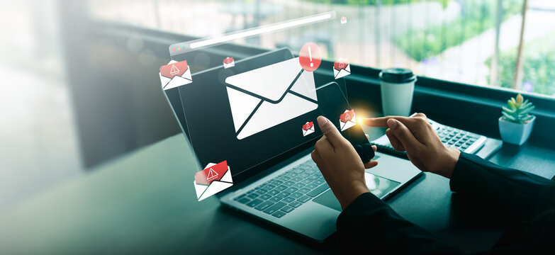 Businessperson using smartphone and laptop receiving suspicious malware warning email notification, concept of spam detection, phishing scam alert, cybersecurity risk, and online protection