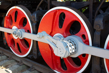 Locomotive wheels in red color close-up.