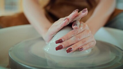 Close up hands of artisan's shaping creating clay bowl in pottery wheel in studio. Pottery art and creativity, handmade ceramic art, and craftsmanship in traditional ceramic workshop