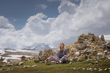 Young Woman Meditating in Mountains