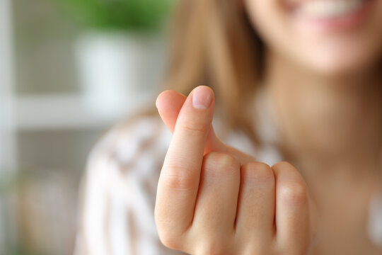 Woman hand gesturing heart shape with fingers