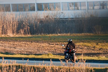 Fototapeta premium Solo biker riding fast on empty road