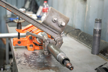 A mechanical engineer is using friction tong to tightening a tool which is gripped on the...