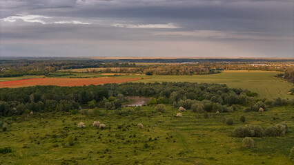 Prahova County Summer Landscape. An aerial view showcases the diverse summer landscape of Gherghița, Prahova County, Romania. The scene is a mosaic of green fields and patches of trees .