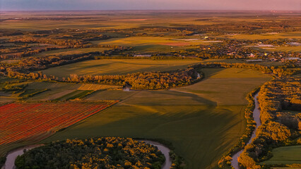 Prahova County Summer Landscape. An aerial view showcases the diverse summer landscape of Gherghița, Prahova County, Romania. The scene is a mosaic of green fields and patches of trees .