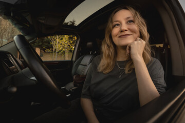 Stylish Young Woman Driving Luxury SUV