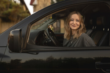 Stylish Young Woman Driving Luxury SUV