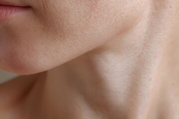Close-up of glowing skin with natural pores and gentle shadows under studio lights.