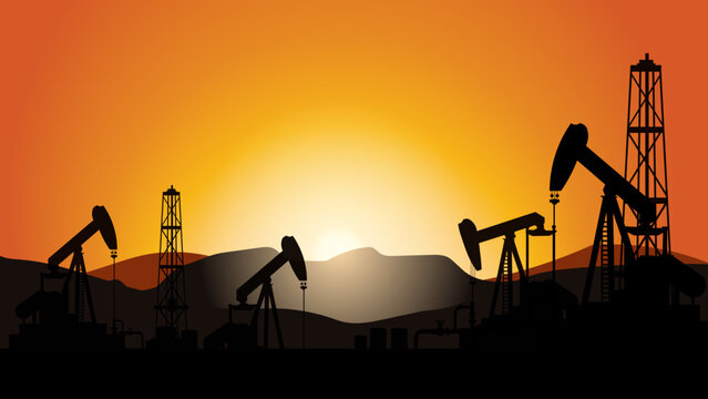 Oil pump silhouettes at sunset with desert hills and warm orange sky