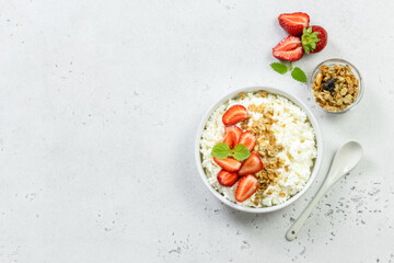 Healthy breakfast, cottage cheese strawberry bowl. Top view, copy space, flat lay.