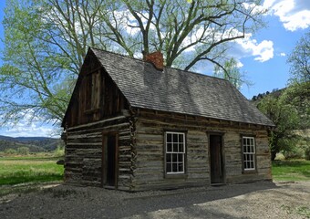 farmland, hills,  and the nineteenth century  childhood homstead of the legendary outlaw, butch cassidy,   in circleville, utah, on a sunny summer day  