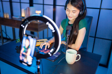 Content creator Young asian woman influencer creating content in home studio entertainment and...