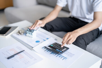 Saving money. Man calculate finances home pay bills taxes savings economy financial at home and...