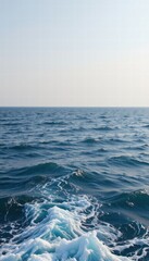 Serene Ocean Waves Under a Clear Sky with Gentle Ripples and Soft Foam in the Morning Light for Tranquil and Relaxing Imagery