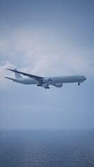 Airplane in the sky, over the cloudy sky