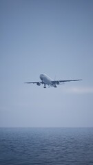 Airplane in the sky, over the cloudy sky