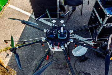 Aerial Filming Rig Awaits Launch An Eight-Rotor Drone Preparing for Flight Above Outdoor Event...