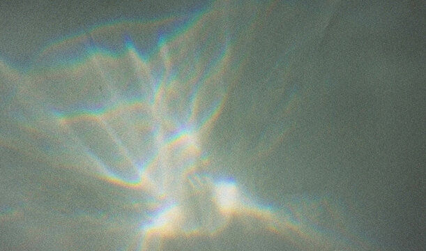 Blurred water texture overlay effect for photo and mockups. Organic drop diagonal shadow and light caustic effect on a white wall. Shadows for natural light effects