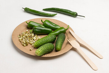 Cucumbers, Sprouted mung bean sprouts and green peppers on cardboard disposable plate