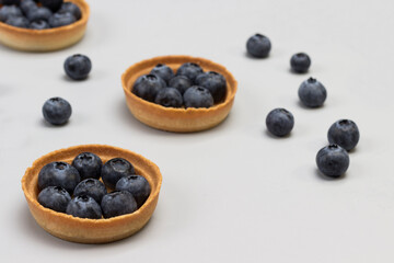 Tartlets with blueberries. Blueberries on table